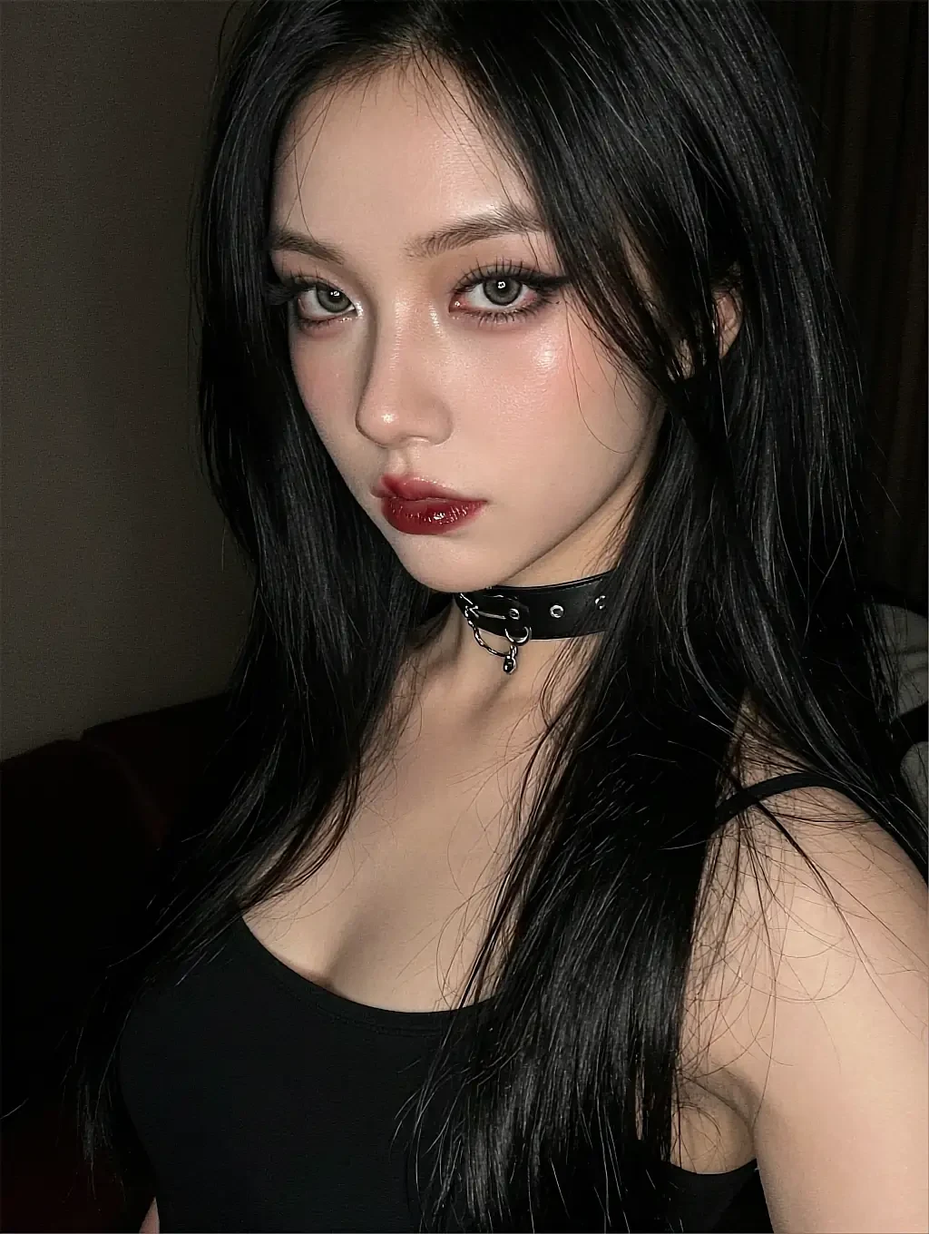 Fictional AI character with black hair and a choker, close portrait in a dark room